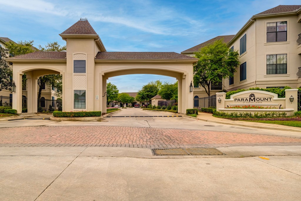 A large archway entrance to a residential area with the name
